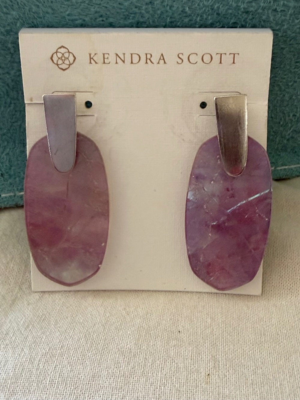 Kendra Scott Aragon Amethyst drop earrings with silver trim.